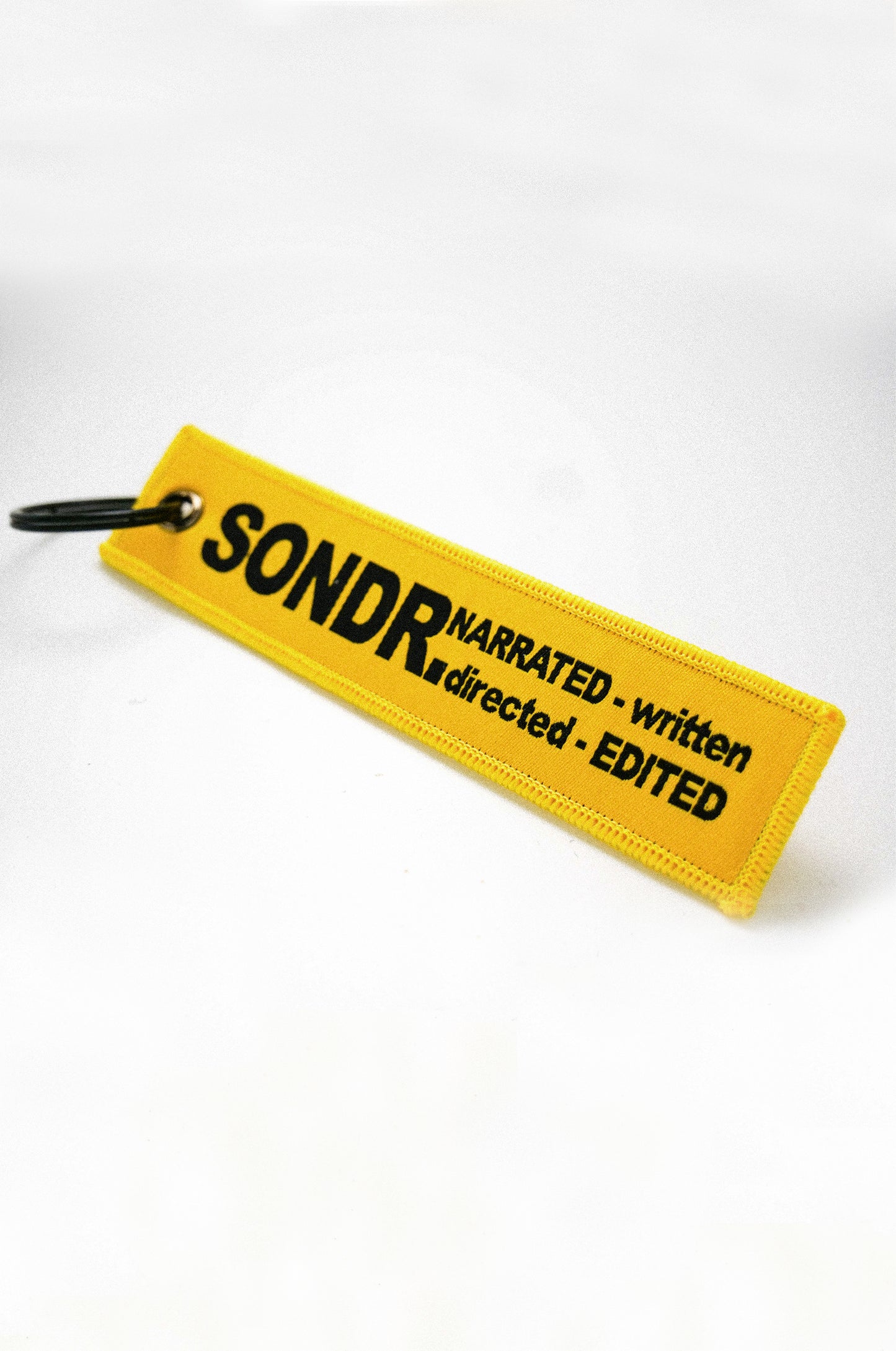Spotlight Image of Yellow SONDR. Flight Tag on angle
