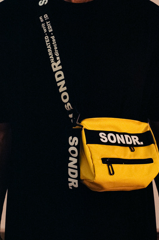 Close up shot of SONDR. Yellow Side Bag Product Image. Showing shoulder trap print & yellow tag
